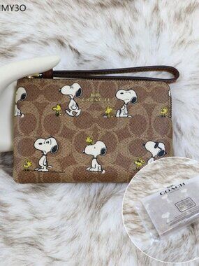 Coach x Peanuts Corner Zip Wristlet In Signature Canvas With Snoopy Print CBS82